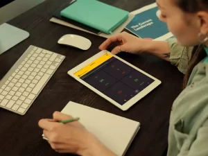 Woman at desk with iPad and ShareMyToolbox app