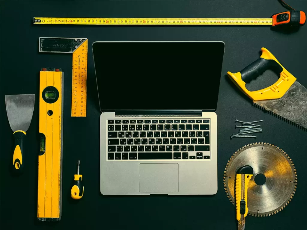 A collection of tools around a laptop